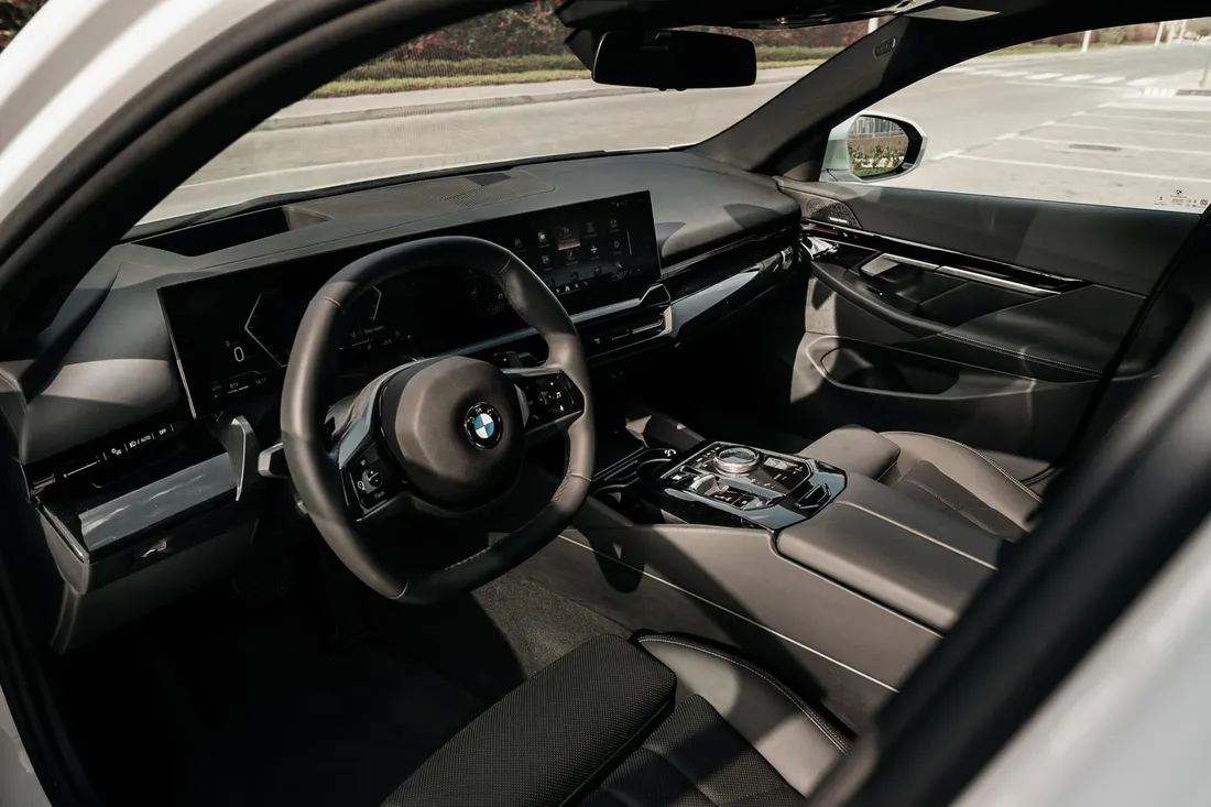 BMW 530i — driver cockpit and centre console from the open door