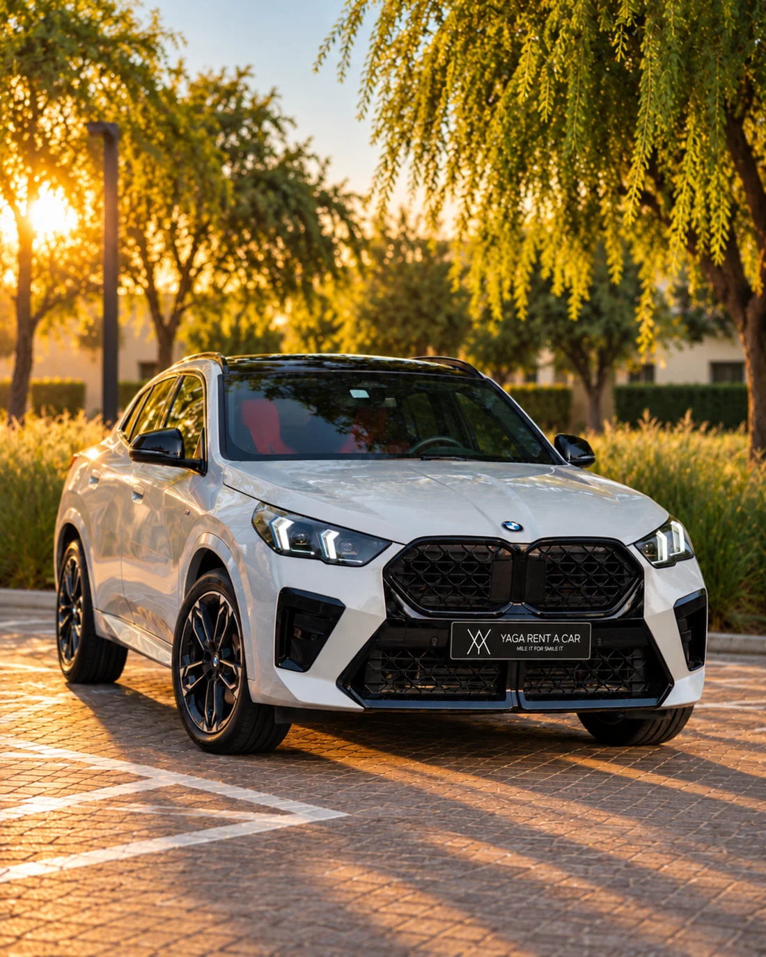 BMW X2 White — front exterior on a sunlit paved area