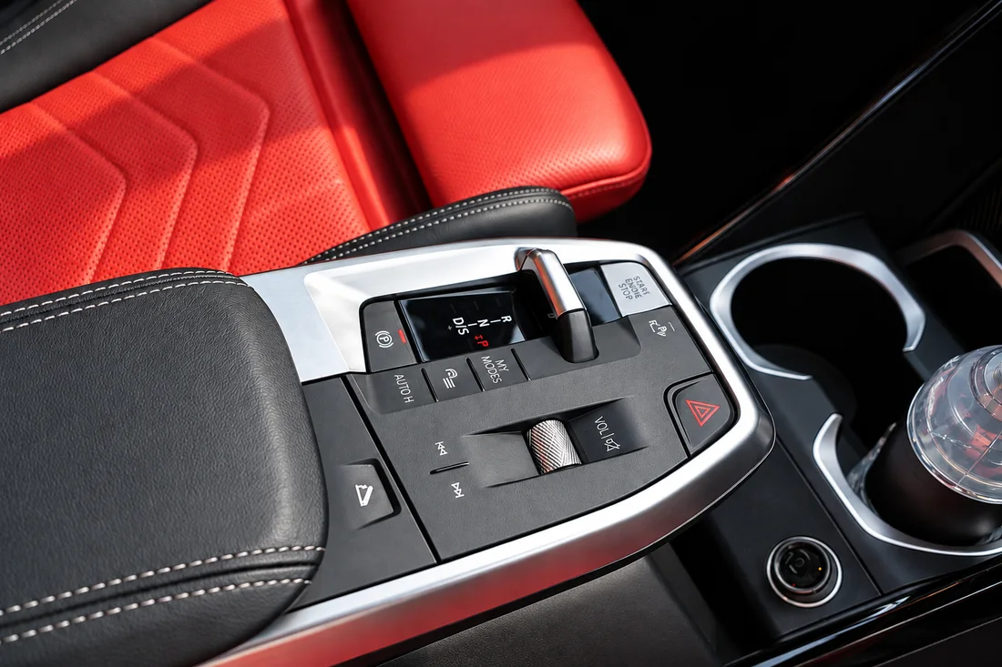 BMW X2 White — centre console switches beside red seat upholstery
