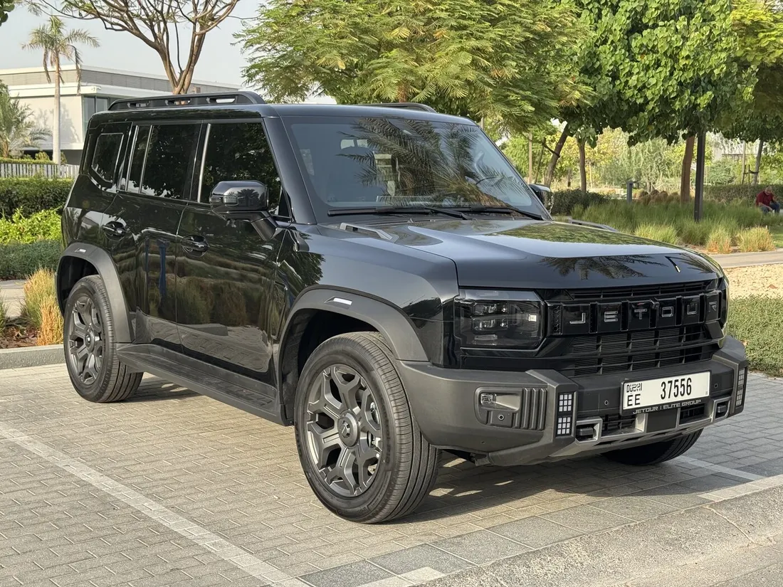 Jetour T2 Green Interior — front three-quarter exterior beside trees
